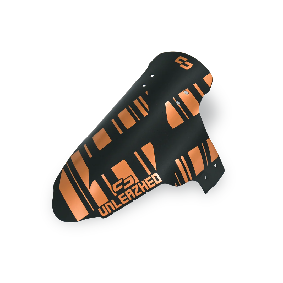 unleazhed - M01 copper, Schienbeinschoner, Kunststoff, Schwarz-orange, Geometrisches Muster, Schutzschale